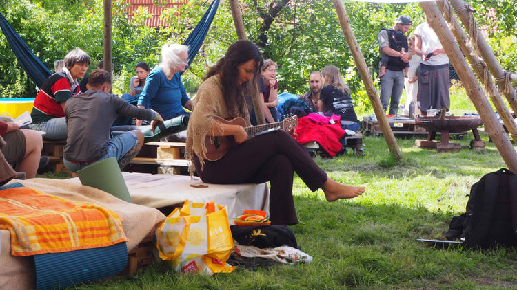 Gitarre spielen im Garten von AHO Bio